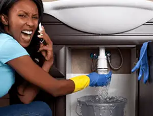 Emergency plumbing repair for a leaking sink drain under a bathroom vanity in Pittsburgh, PA